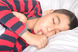 adolescent boy sucking thumb while sleeping